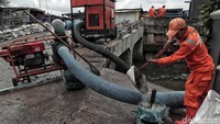 Seorang petugas sedang menyiapkan pompa mobile untuk diletakkan sebagai bentuk pencegahan banjir rob.