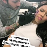 Beberapa waktu lalu penyanyi Selandia Baru Kelsy Karter unggah postingan di Instagram yang jadi perbincangan. Ia memperlihatkan tato gambar wajah Harry Styles. Tak tanggung-tanggung, tato tersebut ditempatkan pada wajahnya, tepatnya di pipi. Dalam unggahan foto tersebut, Kelsy Karter tidak memberi penjelasan hanya menulis, mama, lihat apa yang aku buat aku lakukan.Foto: Instagram @kelsykarter