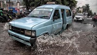 Sejumlah kendaraan melintasi Jalan Bukit Gading Raya, Jakarta Utara, yang tergenang air.