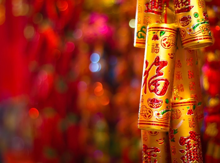 Young asian woman pastes spring couplet. It is the tradition of Chinese culture to stick spring couplet to the doors for Chinese New Year. The word on the spring couplet means spring