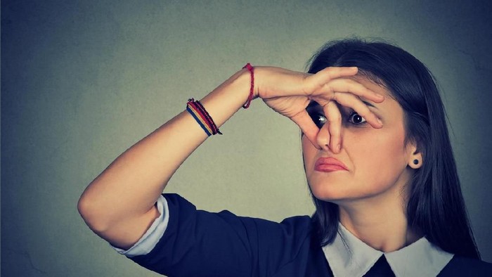 bau badan Stinky. Closeup portrait headshot woman pinches nose with fingers hands looks with disgust something stinks bad smell situation isolated on gray wall background. Face expression body language reaction