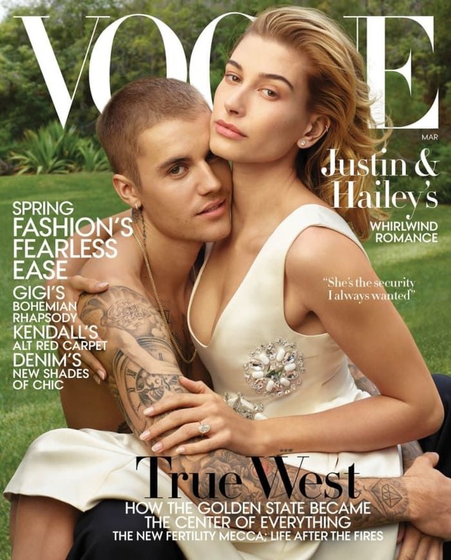 Inilah penampilan perdana Justin Bieber dan Hailey Baldwin sebagai suami-istri di sampul majalah Vogue edisi Maret 2019. Untuk pemotretan tersebut, Hailey menebar aura seksinya dalam balutan gaun Prada berbelahan dada rendah. Sementara itu, Justin tampil telanjang dada yang mengumbar tato di lengannya. (Foto: Vogue/Annie Leibovitz)