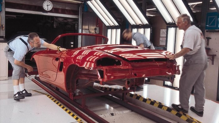 STUTTGART, GERMANY:  (FILEPHOTO)  Workers check the paint on Porsche cars at the companys main manufacturing plant in Stuttgart, Germany, in this undated file photo. Porsche announced a 71 percent rise in net profit October 11, 2002, thanks to increased demand for its higher end models with higher profit margins.  (Photo by Porsche AG/Getty Images)