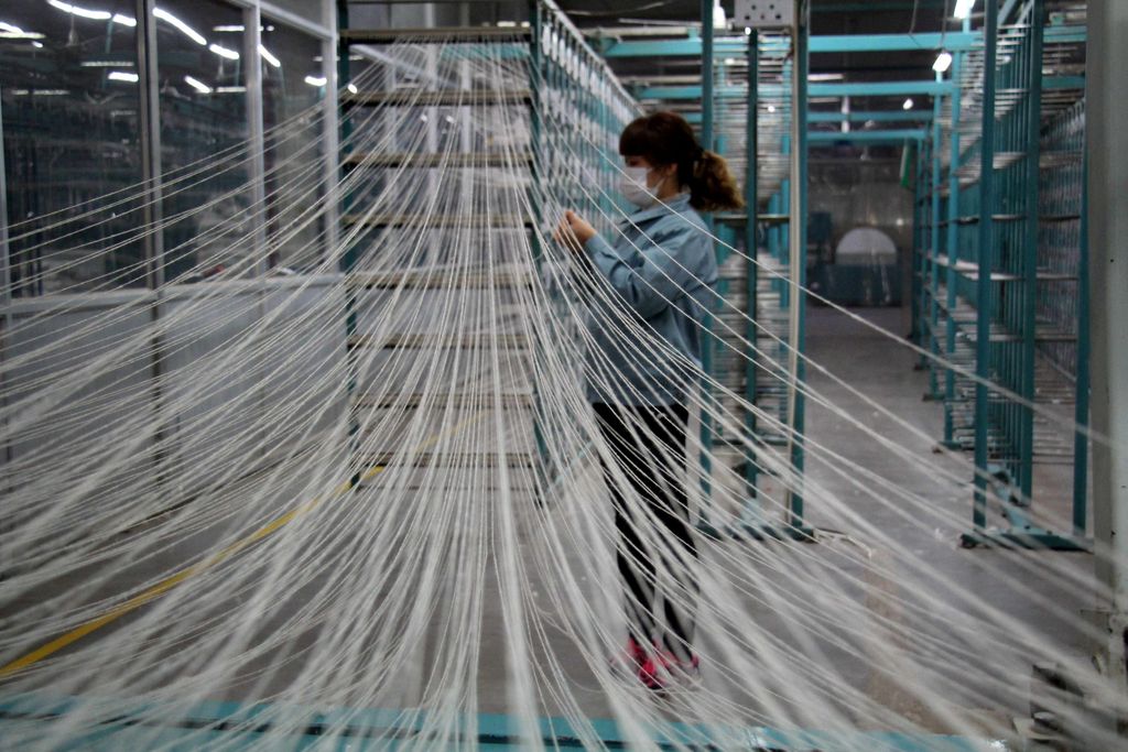 A woman works at a workshop of a textile manufacturer in Binzhou, Shandong province, China February 11, 2019.   China Daily via REUTERS  ATTENTION EDITORS - THIS IMAGE WAS PROVIDED BY A THIRD PARTY. CHINA OUT.