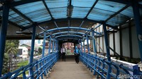 Ketiadaan atap pelindung di beberapa bagian membuat warga enggan melintasi jembatan tersebut saat hujan.