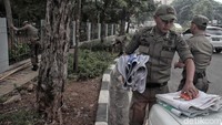 Baliho yang ditertibkan dilipat kemudian diangkut menggunakan mobil Satpol PP.
