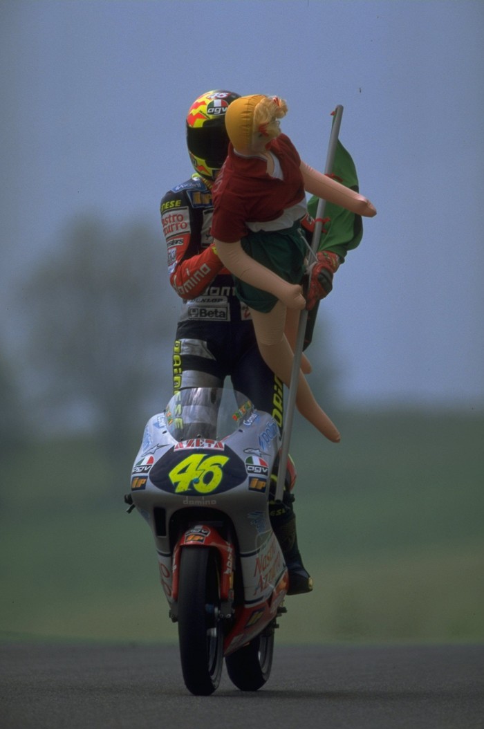 18 May 1997:  Valentino Rossi of Italy celebrates with an unlikely companion after the Italian Motorcycle Grand Prix at Mugello in Italy. \ Mandatory Credit: Mike Cooper /Allsport