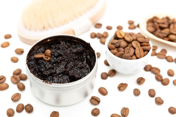 Aromatic botanical cosmetics. Dried herbs flowers mixture, aromatic homemade scrub paste made from coffee grounds and oils. Holistic herbal DIY skincare beauty hack.