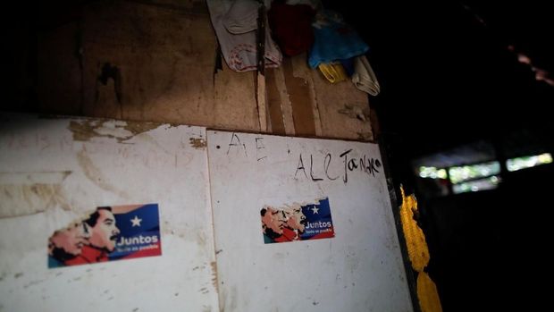 Stickers showing former Venezuelan President Hugo Chavez and President Nicolas Maduro are stuck to the door of Maria Guitia's home near San Francisco de Yare, Venezuela, February 20, 2019. REUTERS/Carlos Garcia Rawlins  SEARCH 
