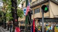 Seorang petugas memasang bendera AS dan Korea Utara di setiap sudut jalan di kota Hanoi, Vietnam, jelang pertemuan tingkat tinggi pemimpin dunia tersebut. Carl Court/Getty Images.