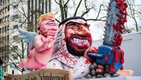 Pawai tahunan kota Dusseldorf ini terkenal dengan satir politiknya yang menggunakan beragam hiasan untuk menyampaikan kritik sosial dan politik mereka atas beragam hal yang terjadi di dunia. Lukas Schulze/Getty Images.
