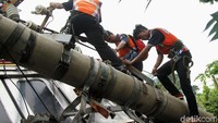 Petugas harus memanjat tiang yang menimpa KRL untuk memotong arus listrik aliran atas (LAA) di jalur tersebut.