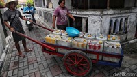 Pedagang menyusuri gang-gang untuk menjajakan air bersih.