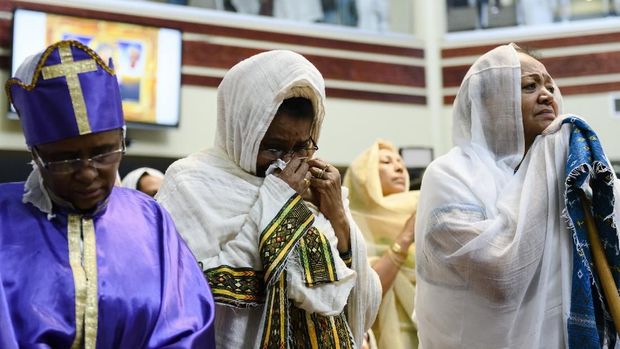 Members of the Ethiopian community take part in a special prayer for the victims of the Ethiopian Airlines flight ET302 crash, at the Ethiopian Orthodox Tewahedo Church of Canada Saint Mary Cathedral in Toronto, on Sunday, March 10, 2019. Ethiopian Airlines flight ET302 crashed shortly after takeoff from Ethiopia's capital on Sunday morning, killing all on board, authorities said, including 18 Canadians. (Christopher Katsarov/The Canadian Press via AP)