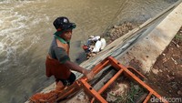 Sebuah tangga pun digunakan untuk petugas agar dapat turun ke bawah kali.
