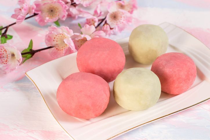 Japanese Dango, Japanese Traditional Sweets. Dango green tea dumplings flavors topping with red bean paste (anko) served with hot tea.