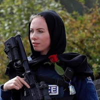 Tak hanya memakai hijab, beberapa di antara mereka juga mendatangi masjid dan melindungi para jamaah saat melakukan salat Jumat. Mereka ingin membuktikan bahwa terorisme tidak memecah belah mereka. Foto: REUTERS/Jorge Silva