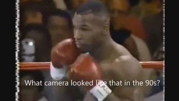 Pada 2016, semua mata tertuju pada sebuah penampakan benda diduga ponsel berkamera. Foto pertandingan tinju Mike Tyson di tahun 1995 ini menampilkan penampakan salah satu penonton memotret menggunakan ponsel berkamera. Tampak terlihat pula lampu flash kamera menyala. Tentu aneh mengingat di tahun tersebut belum ada ponsel berkamera. Foto: Internet