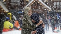 Dua orang pengunjung asyik bermain salju di Trans Snow World Juanda.
