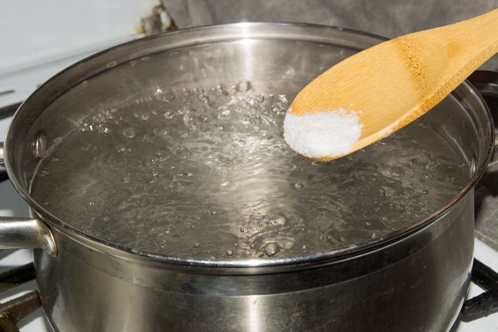 pan of boiling water with spaghetti on the cooker in the kitchen