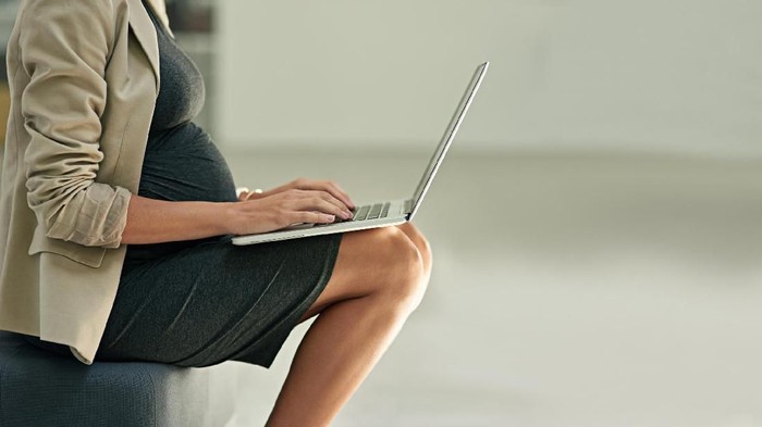 Cropped shot of a pregnant businesswoman using a laptop in an office