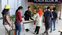 Penumpang yang akan masuk Blok M Plaza diperiksa petugas keamanan.