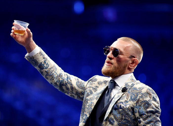 Conor McGregor FILE PHOTO: UFC lightweight champion Conor McGregor of Ireland raises a cup of Irish whiskey during post-fight news conference at T-Mobile Arena in Las Vegas, Nevada, U.S. August 27, 2017. REUTERS/Steve Marcus/File Photo