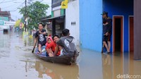 Perahu hilir mudik untuk mengevakuasi warga yang terjebak banjir.