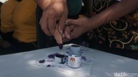 Petugas TPS mengarahkan peserta untuk melakukan pencoblosan. (Foto: Khadijah/detikHealth)