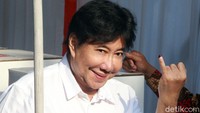 Guruh Soekarnoputra memamerkan kelingkingnya yang telah dicelupkan tinta usai mencoblos di TPS 02 Selong, Kebayoran Baru, Jakarta, Rabu (17/4/2019).