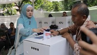 Mulan Jameela memasukkan surat suara ke dalam kotak suara. Foto: Hanif Hawari