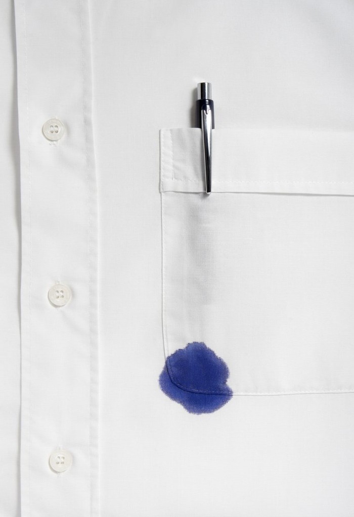 close up of businessman ruined shirt and and leaking pen