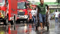 Sebagian pedagang mengevakuasi barang dagangan menggunakan gerobak.