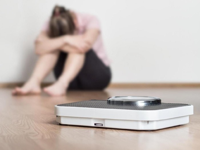 516929130 Woman standing on weight scale showing error message