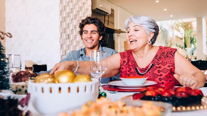 Brazilian grandmother and grandson at family lunch