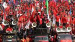 Buruh Bawa Mesin Jahit Raksasa ke Patung Kuda