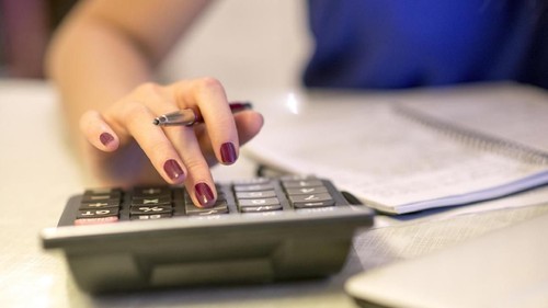Close up of female accountant or banker making calculations