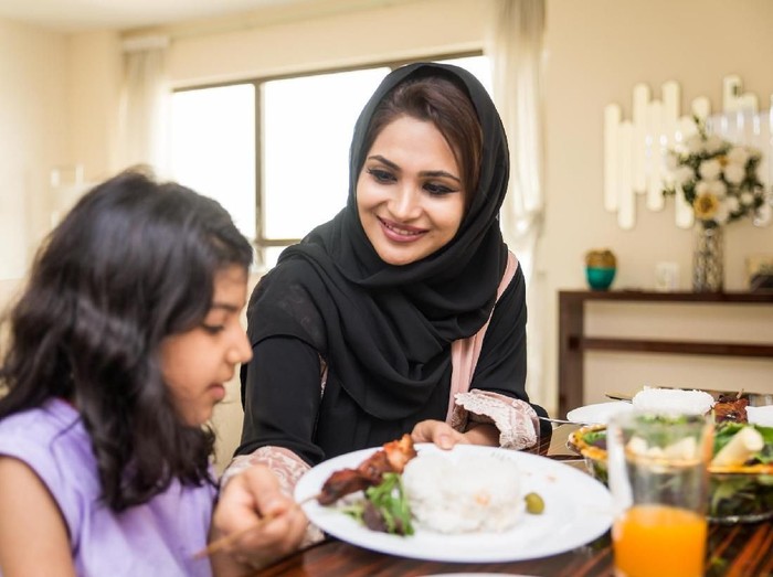 Happy arabian family having fun at home