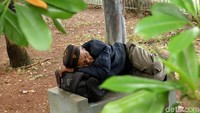 Seorang warga nampak beristirahat di area sekitar Banjir Kanal Timur, kawasan Pondok Kelapa, Jakarta Timur, Senin (6/5/2019).