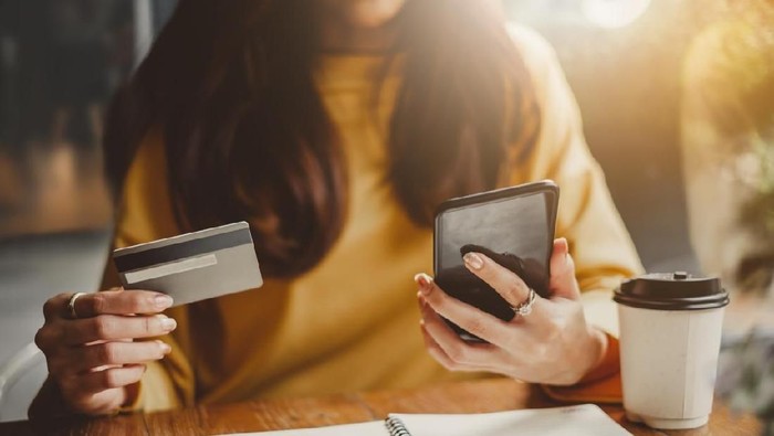 Young woman paying bills/ shopping online with credit card