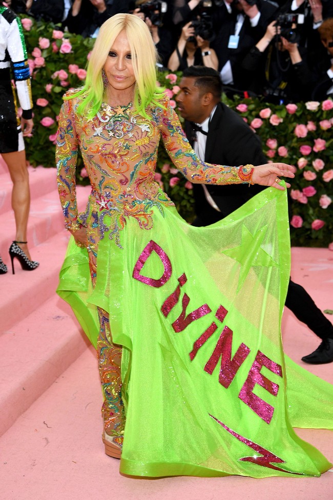 Desainer Donatella Versace tak akan terlewatkan di karpet merah Met Gala dengan bodysuit warna nude dan rok besar hijau neon panjang.  Foto: Getty Images