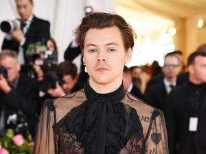 Gaya Mengejutkan Harry Styles Pakai Anting Mutiara dan Sepatu High Heels