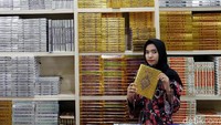 Seorang penjaga toko memperlihatkan salah satu Alquran yang dijual.