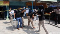 Petugas hilir mudik mengamankan barang yang ditemukan dari toko ponsel Wanky Cell saat proses penggeledahan tengah berlangsung.