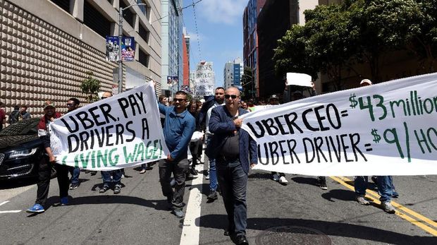 Protestors march through the financial district, demanding fair wages and more transparency during a strike against Uber in San Francisco, California, U.S., May 8, 2019.   REUTERS/Kate Munsch