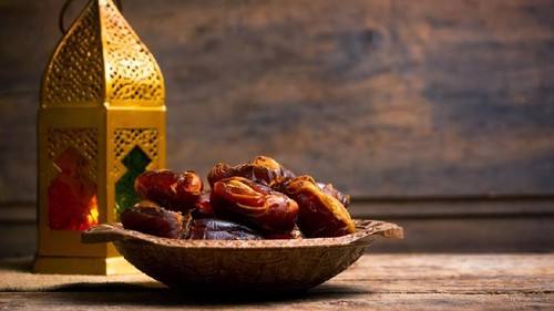 Fresh date fruits with almonds on a table