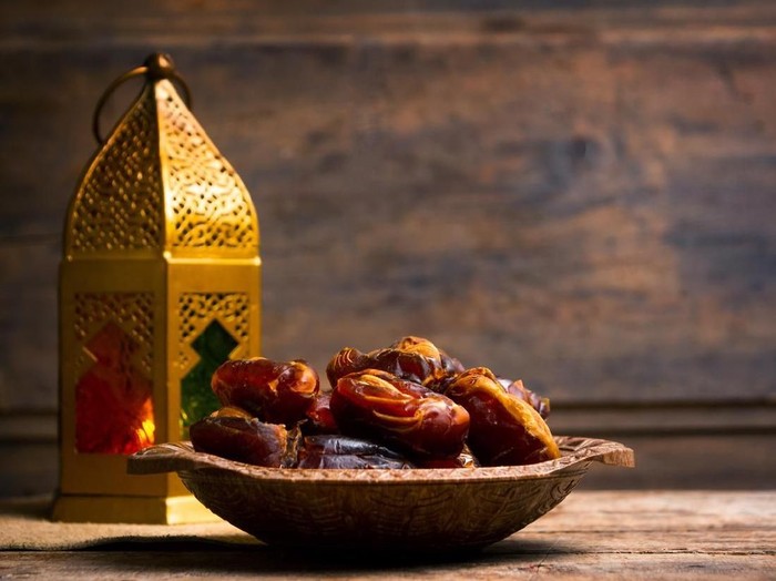 Fresh date fruits with almonds on a table
