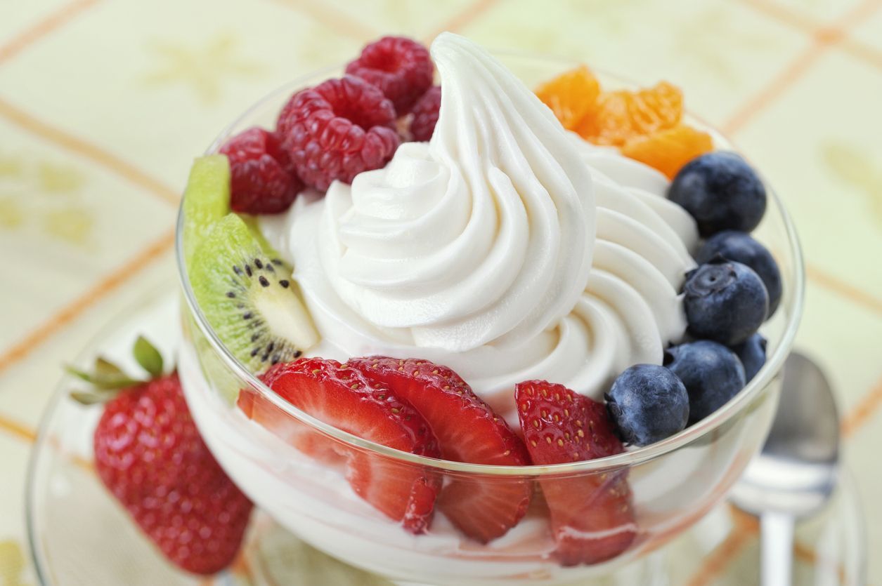 SEVERAL MORE IN THIS SERIES. DIsh of vanilla soft-serve frozen yogurt surrounded by a variety of fresh fruits.  Shallow DOF.