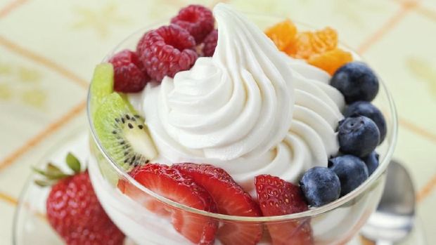 SEVERAL MORE IN THIS SERIES. DIsh of vanilla soft-serve frozen yogurt surrounded by a variety of fresh fruits.  Shallow DOF.