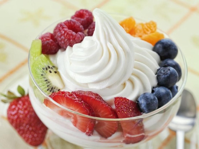SEVERAL MORE IN THIS SERIES. DIsh of vanilla soft-serve frozen yogurt surrounded by a variety of fresh fruits.  Shallow DOF.